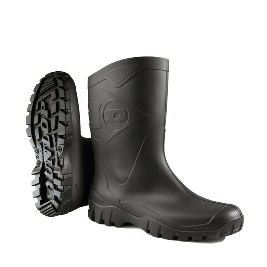 A pair of black, synthetic Dunlop Dee short wide calf rubber wellington boots with flat heels, designed for waterproofing and comfort in outdoor conditions. Ladies Womens