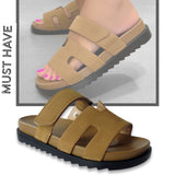 Brown sandals with black soles on a white background
