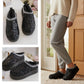 Black sequin slippers shown on a white surface and worn by a person  indoors. Cosy Faux Fur Lined